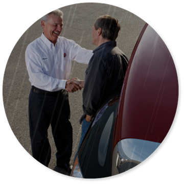 Round cropped image of International Trucks employee shaking hands with a customer