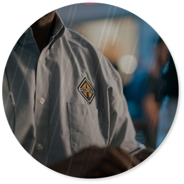 Circle cropped photo of an  International Trucks employee wearing a shirt with the logo on the front