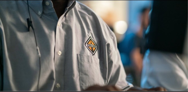 Photo of an  International Trucks employee wearing a shirt with the logo on the front