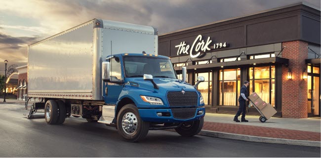 Photo of Blue  International Trucks eMV Series with employee unloading boxes